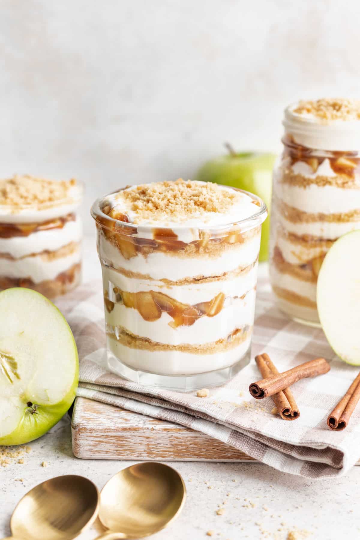 Apple pie parfait on a wooden cutting board.