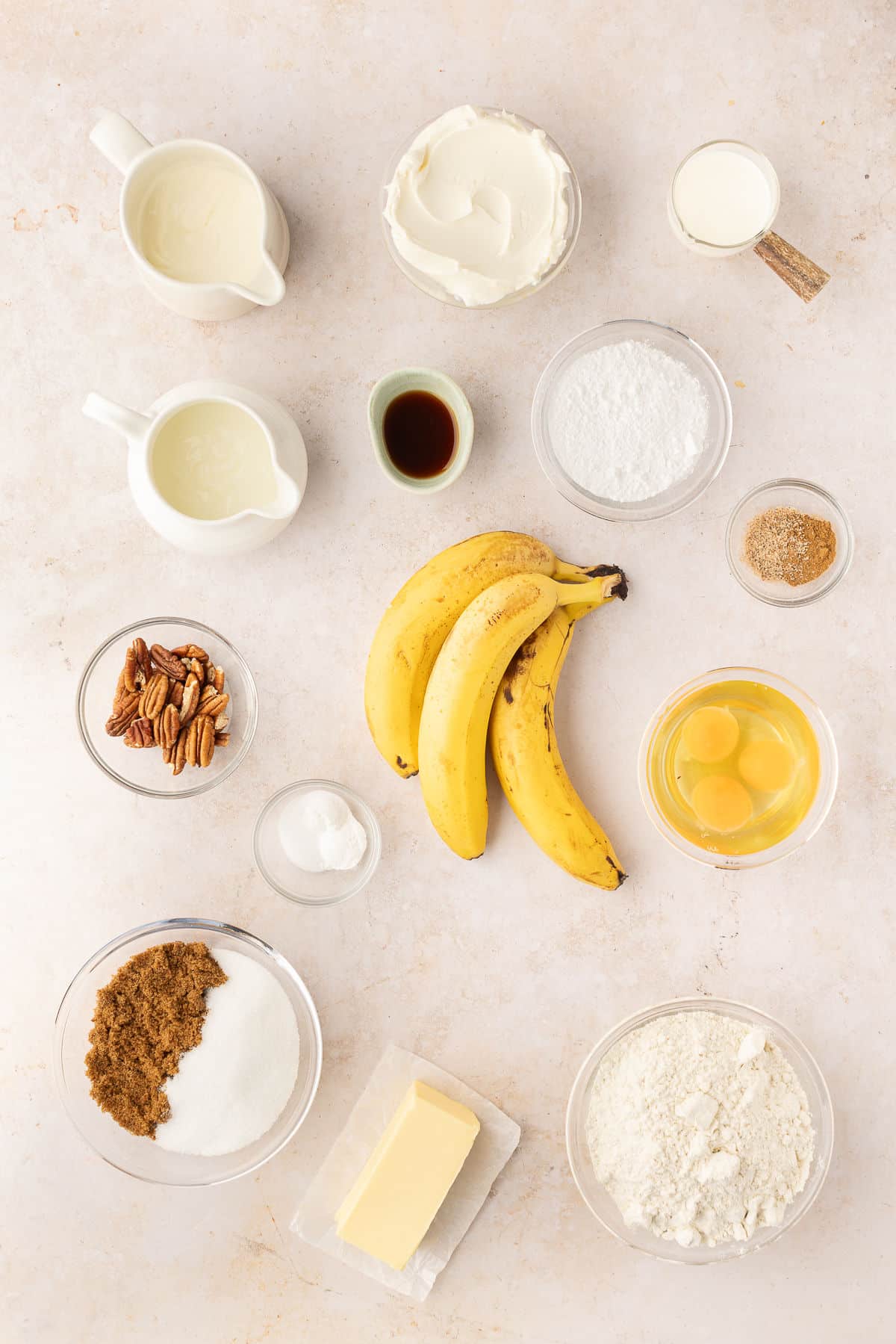 Ingredients for banana cake with cream cheese frosting in dishes. 