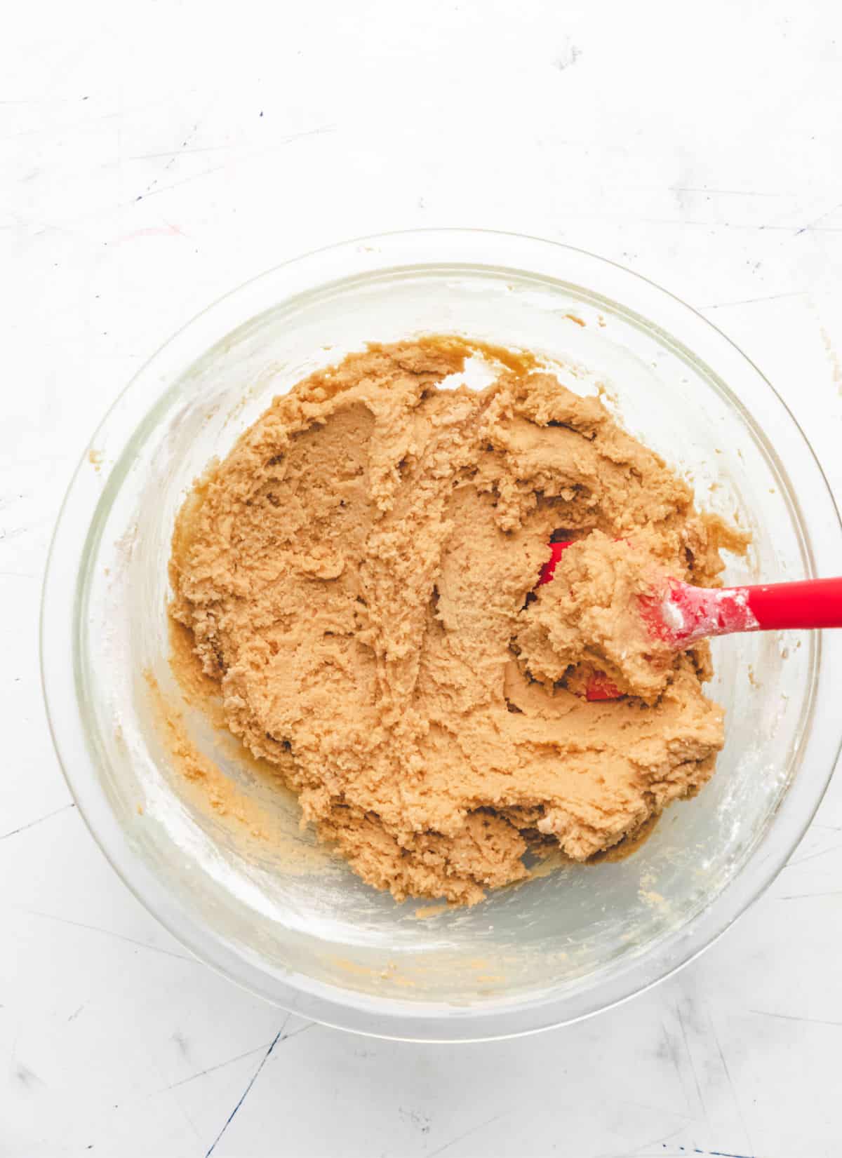 Dry ingredients mixed into wet ingredients for peanut butter cookies. 