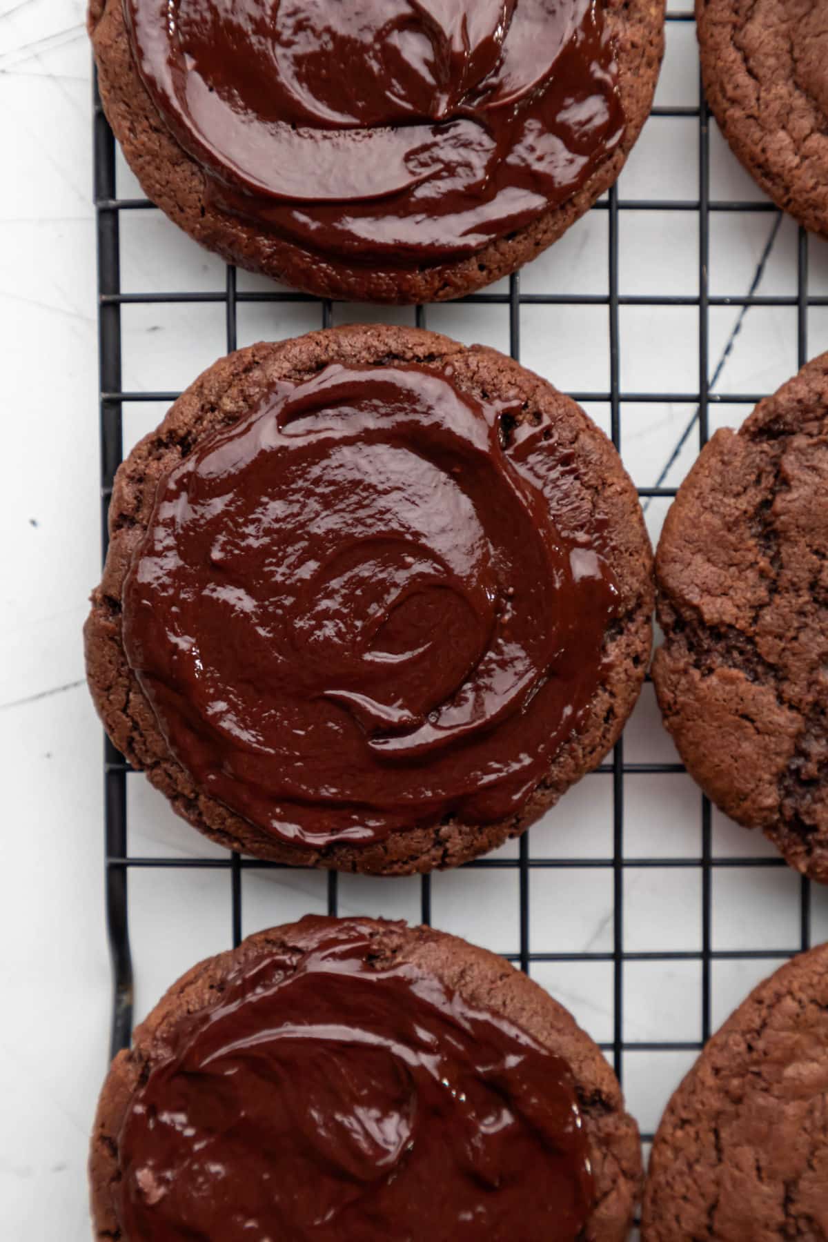 Chocolate ganache spread over chocolate cookies. 