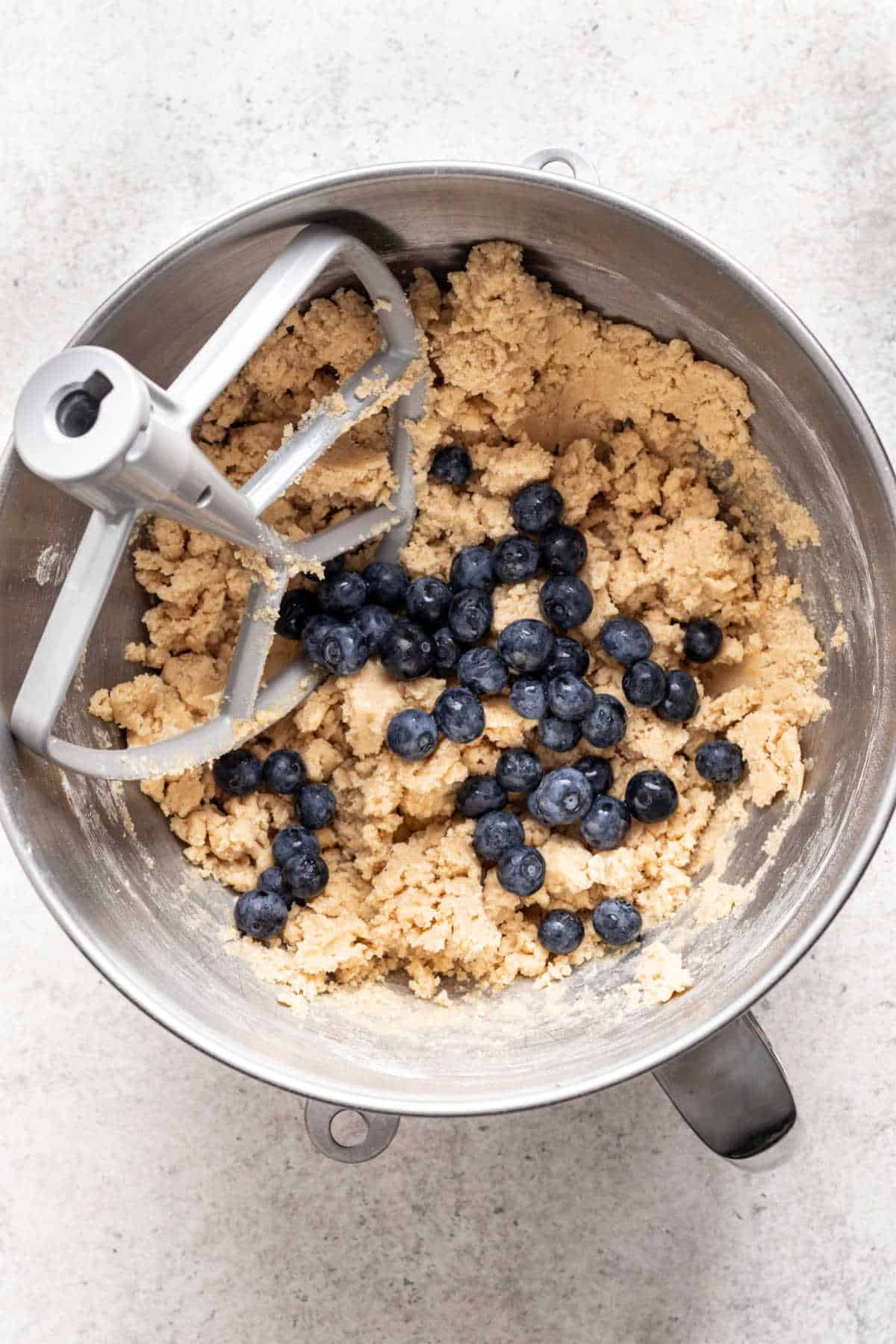 Fresh blueberries on top of blueberry muffin cookie dough.