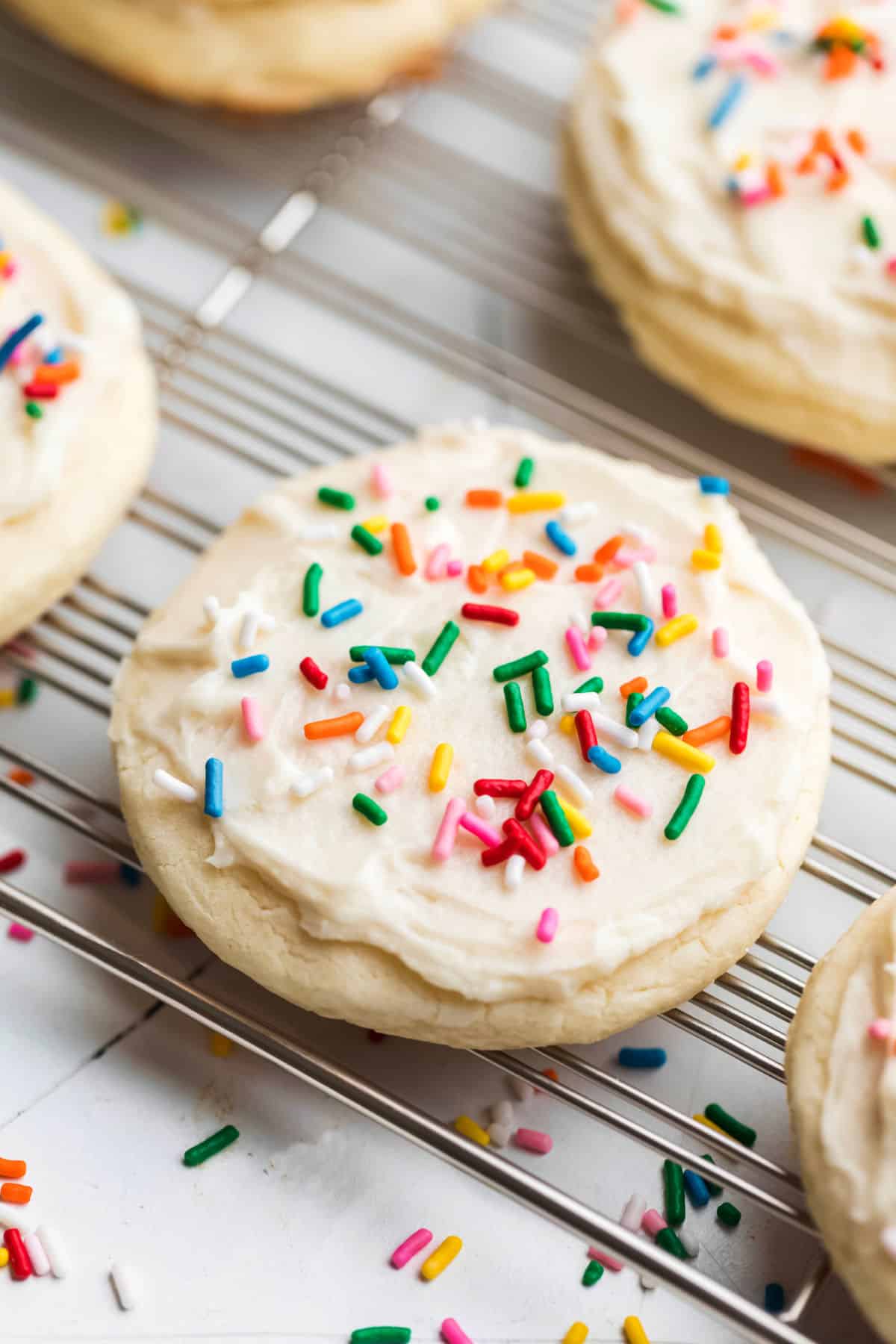 White frosted Lofthouse copycat sugar cookies topped with rainbow sprinkles. 