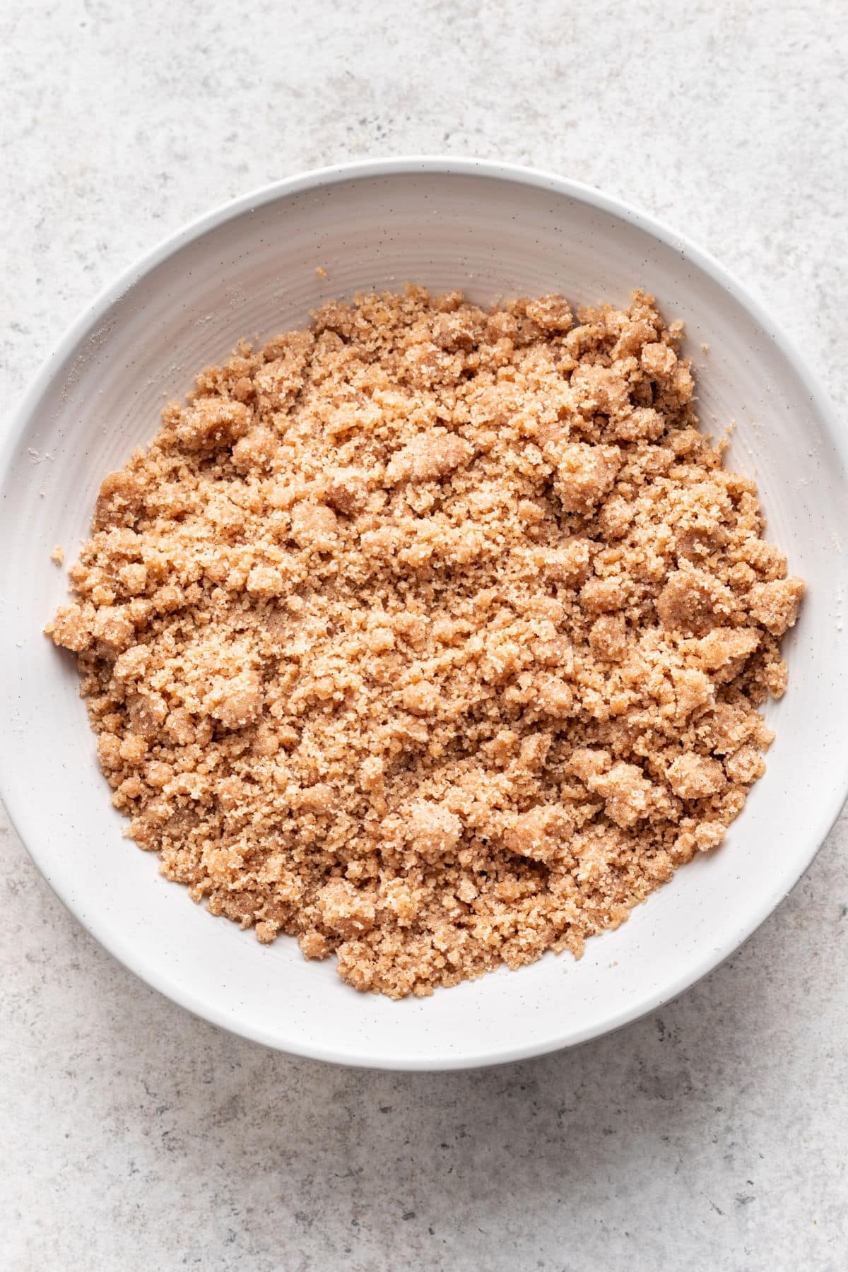 Brown sugar crumble topping in a white mixing bowl. 