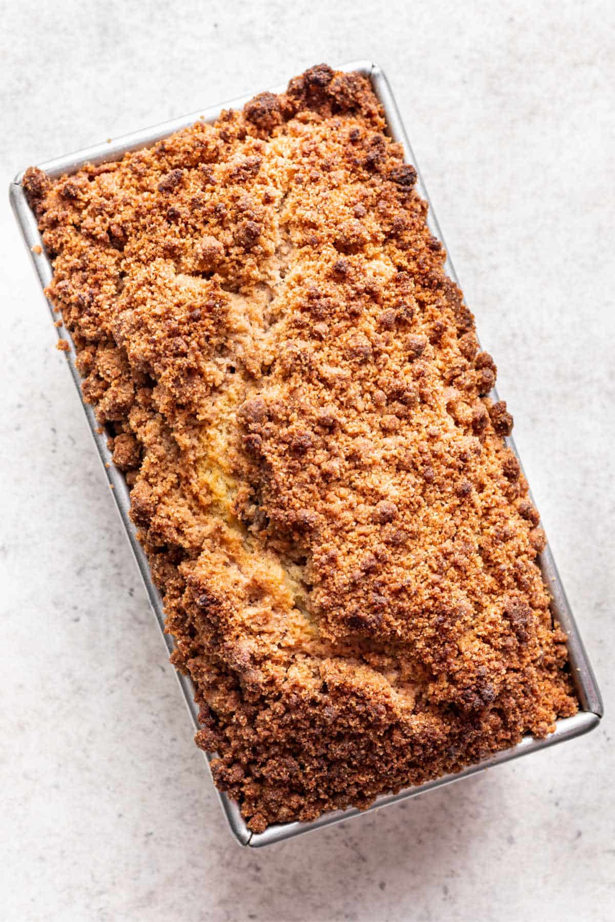 Baked peach cobbler cake in a loaf pan.