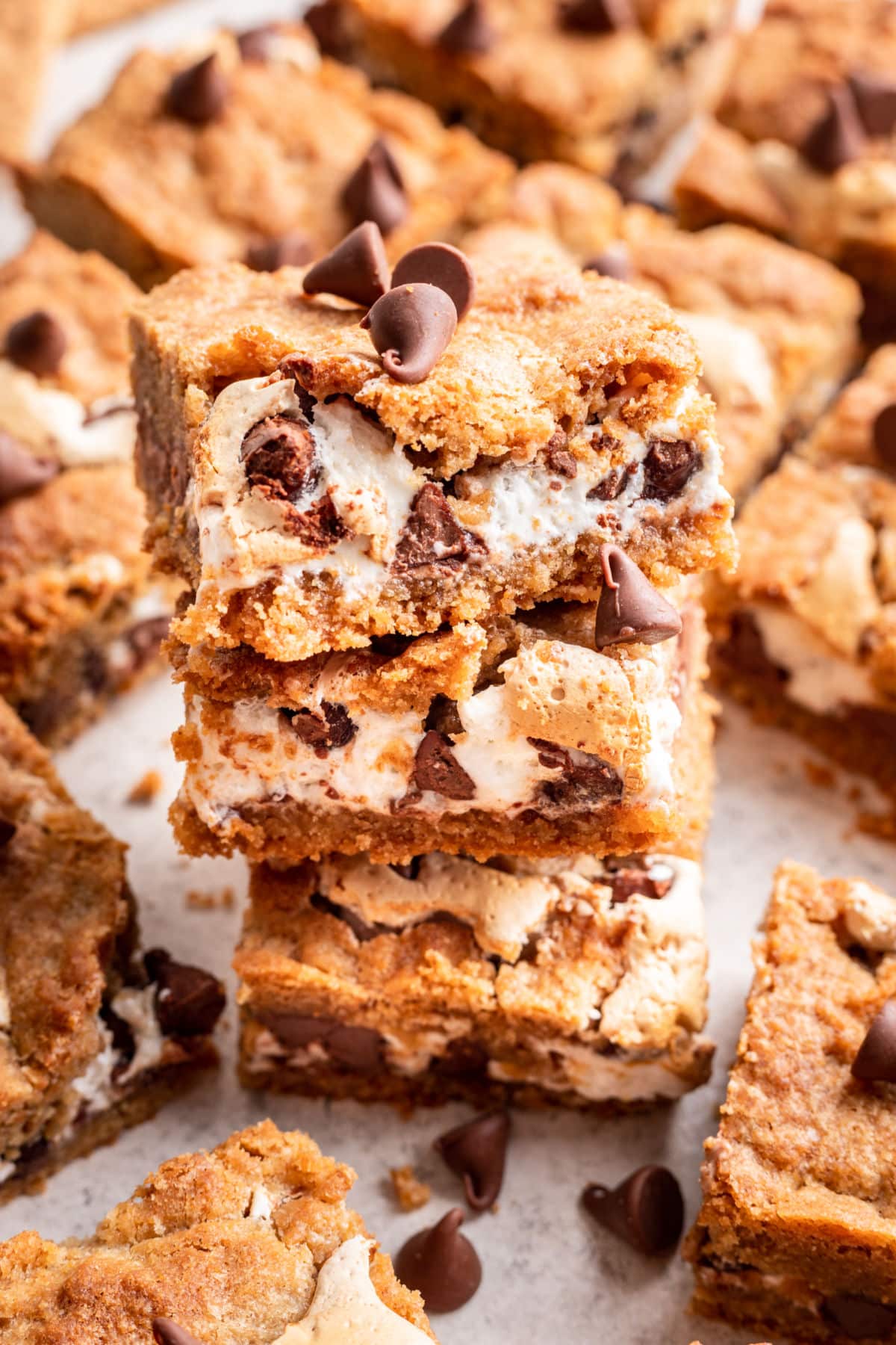 Three s'mores bars stacked on top of each other. 