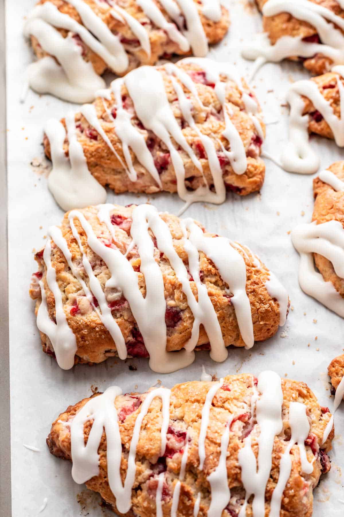 Icing drizzled over strawberry scones. 