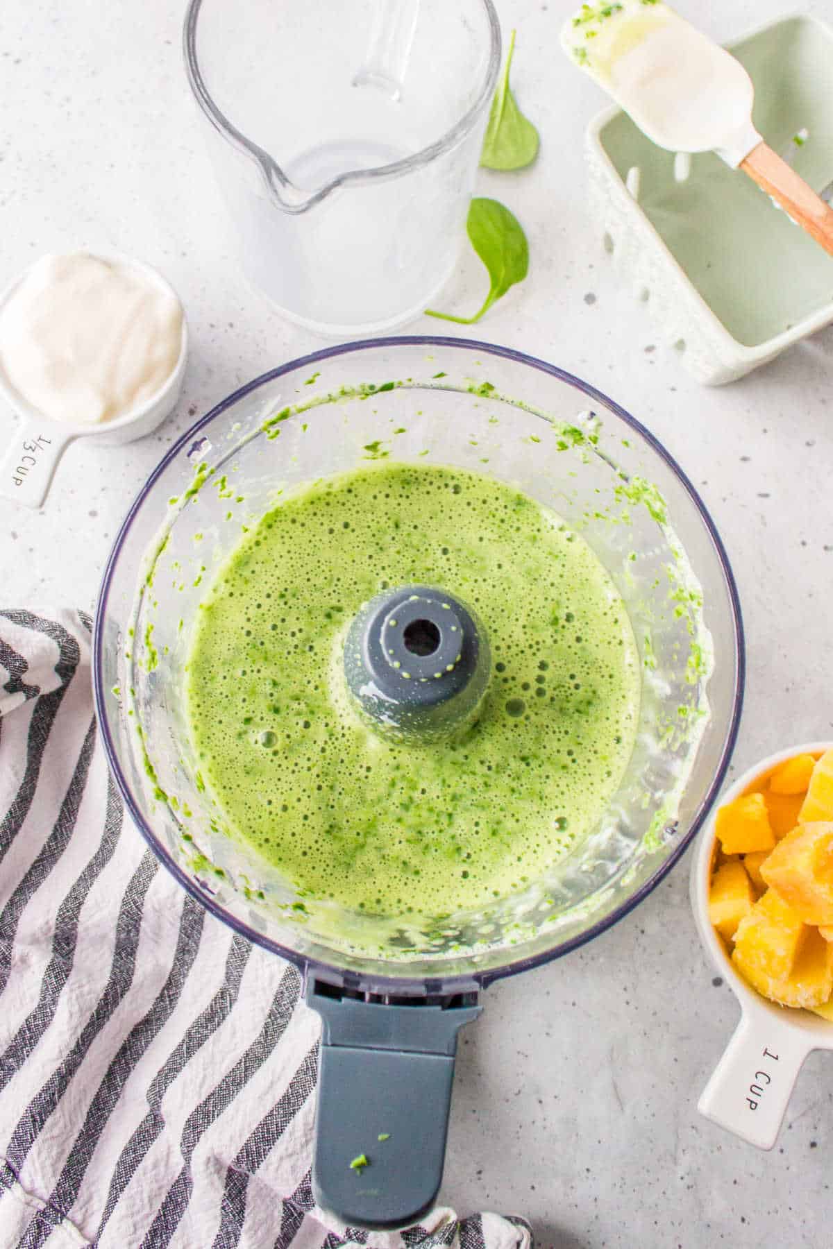Spinach and almond milk blended together in a food processor. 