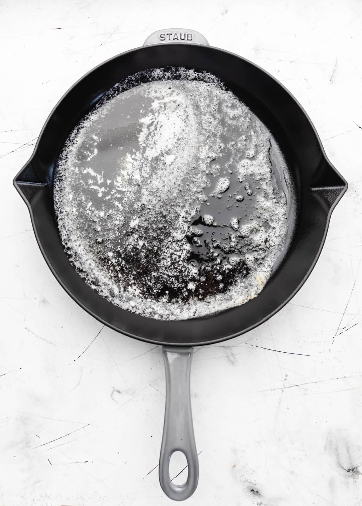Melted butter in a gray skillet. 