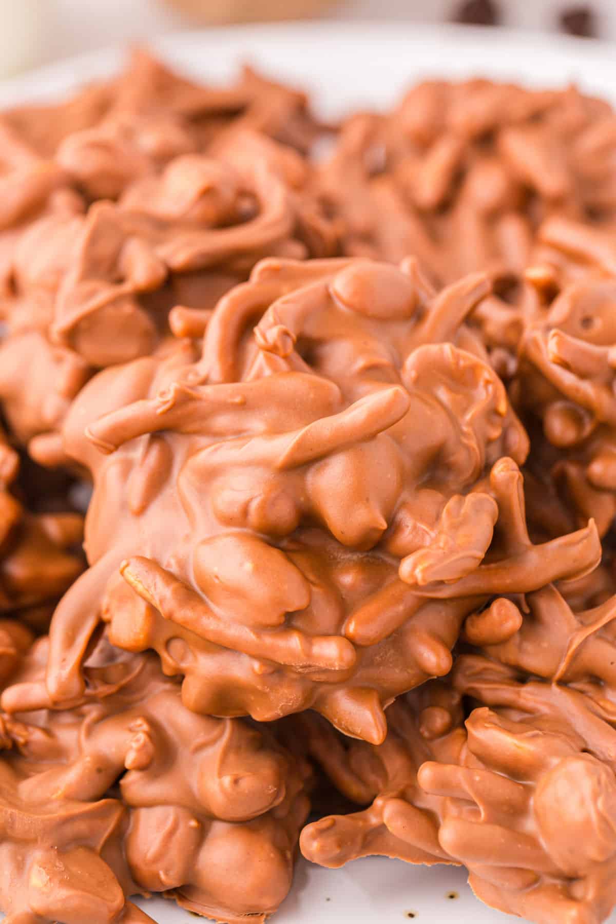 Close up photo of no bake chow mein noodle cookies on a white plate.