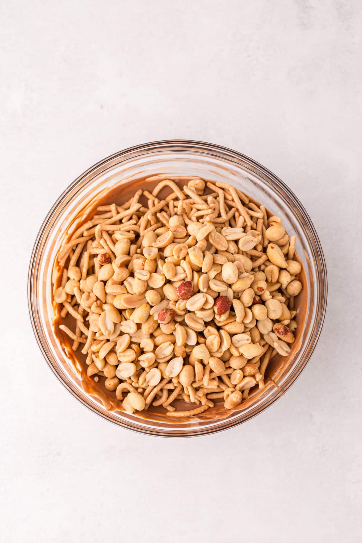 Peanuettes y fideos en Chow Mein en una mezcla de mantequilla de maní derretida. 