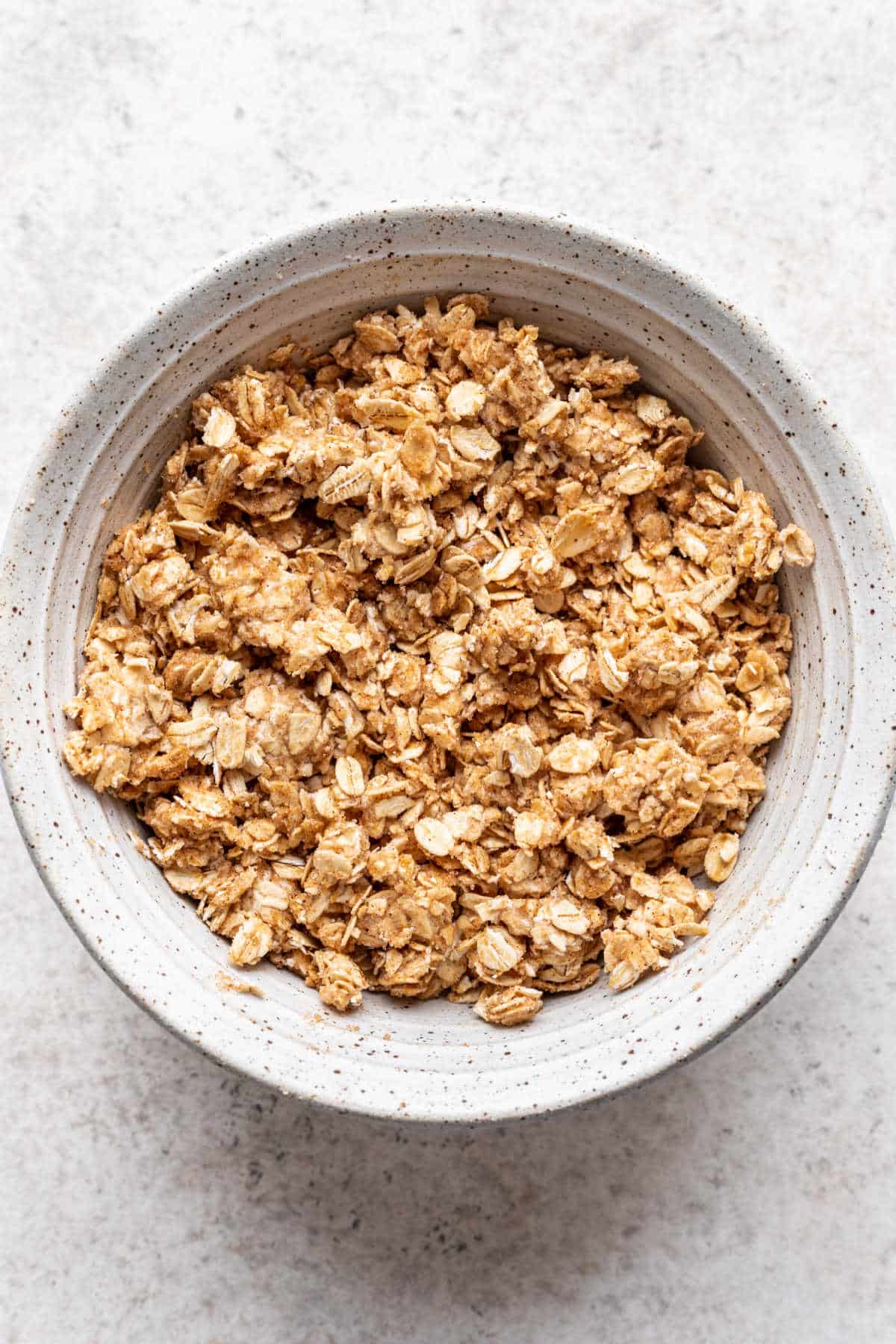 Brown sugar oatmeal filling in a speckled mixing bowl. 