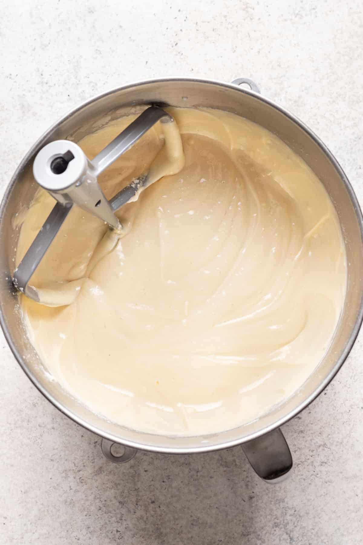 Caramel cake batter in a silver mixing bowl. 