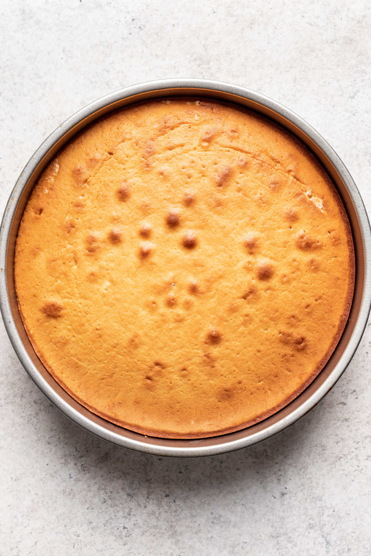 Baked caramel cake in a cake pan. 