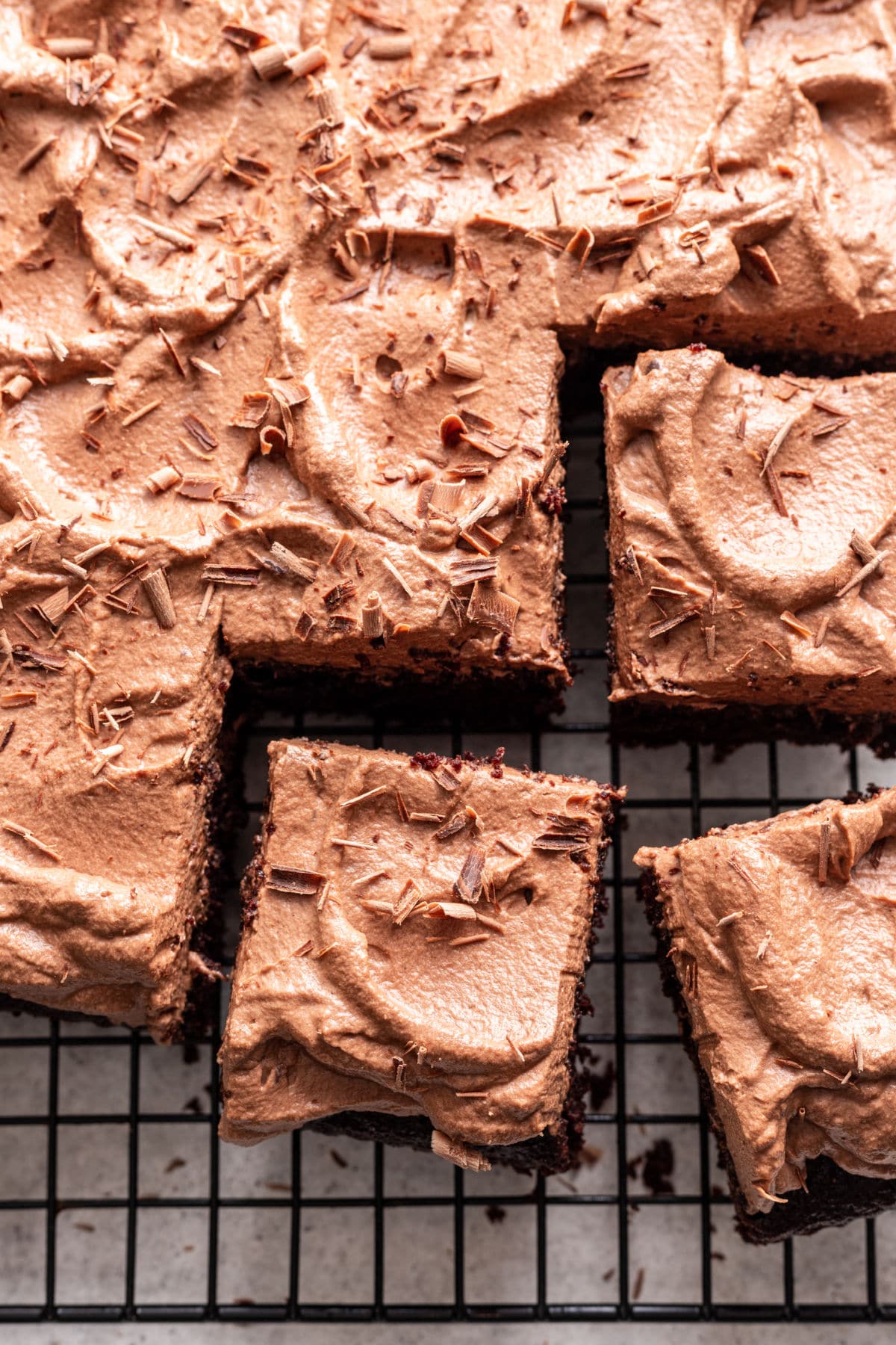 Cut slices of chocolate mousse cake next to the cake. 