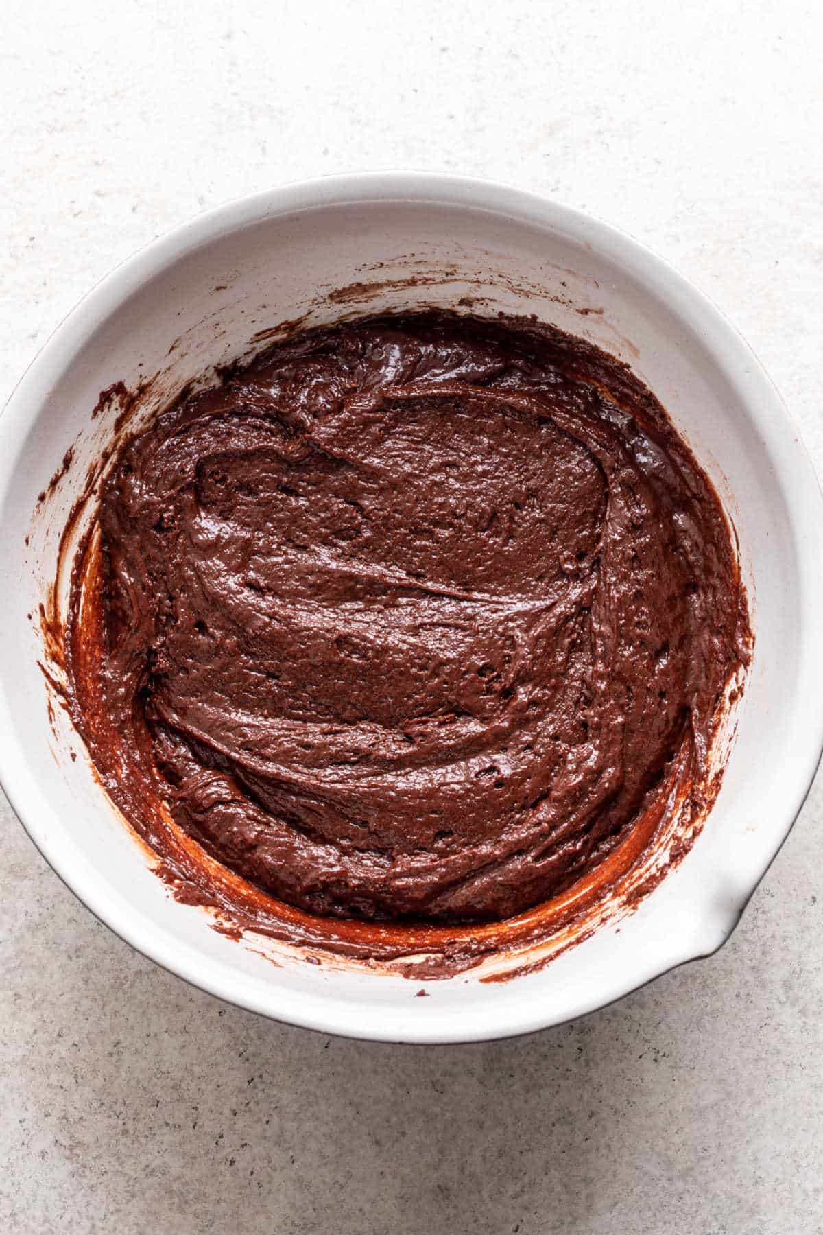 Wet and dry ingredients for chocolate mousse cake mixed together. 