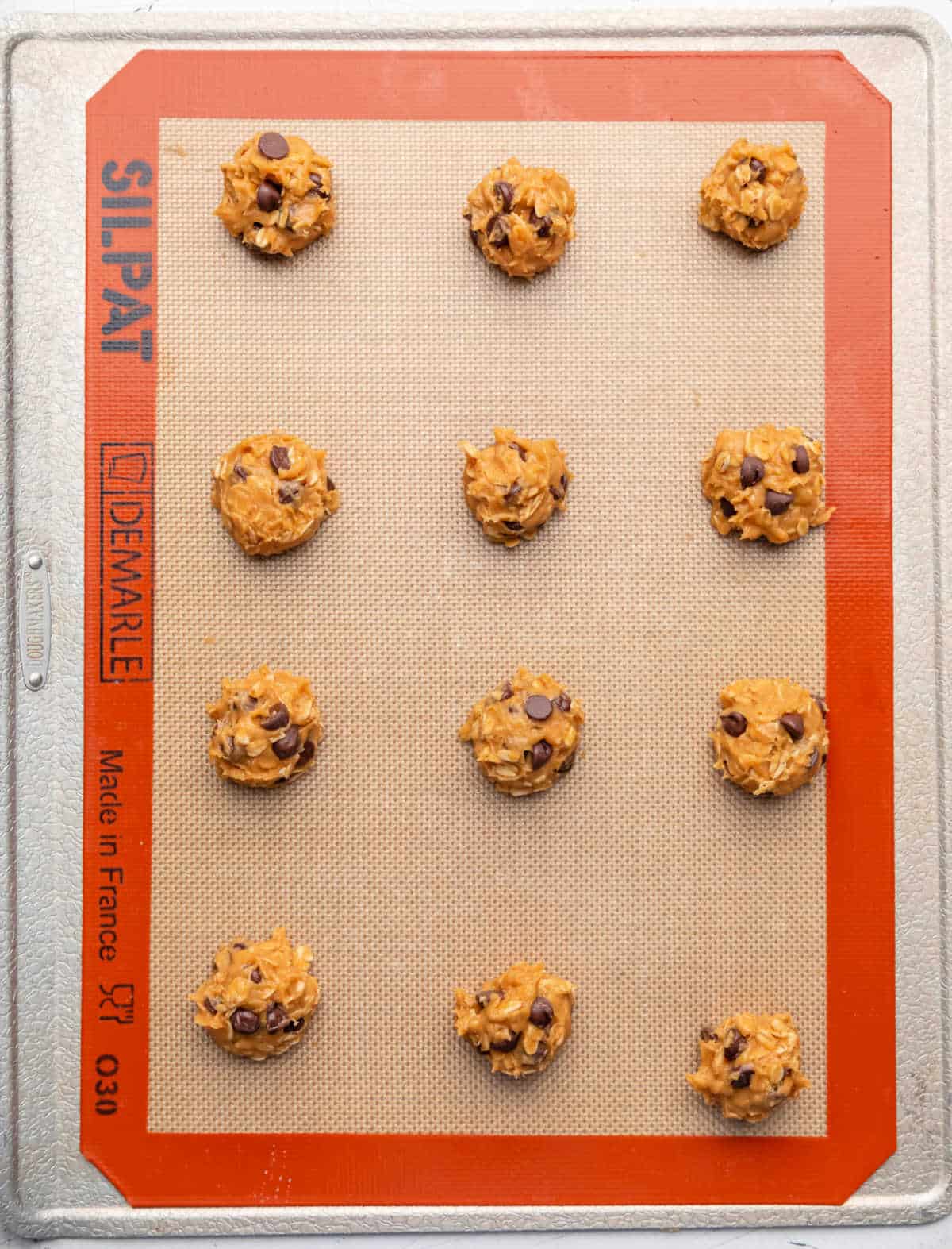 Pumpkin oatmeal cookie dough on a baking sheet. 