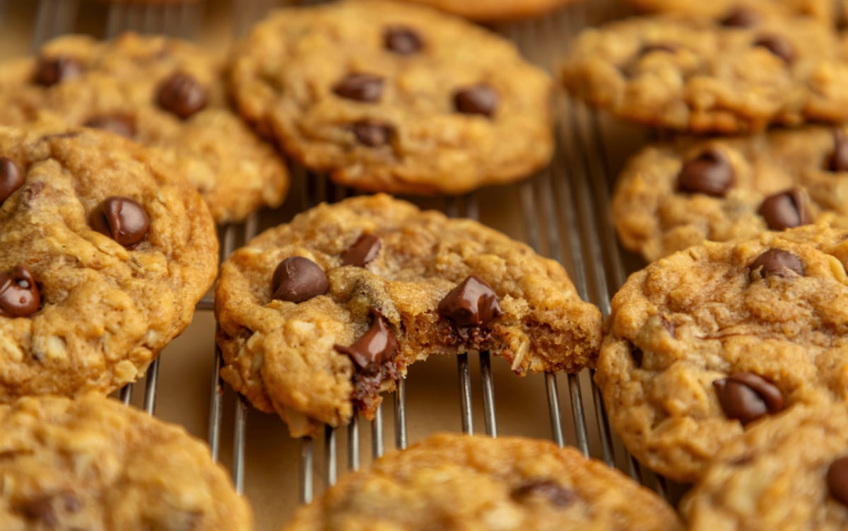 A pumpkin oatmeal cookie with a bite missing. 