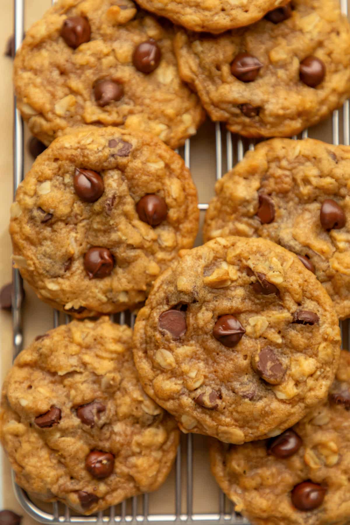 Overlapping pumpkin oatmeal cookies on a wire rack.