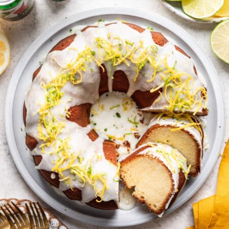 Two slices of 7 up pound cake leaning against the cake.