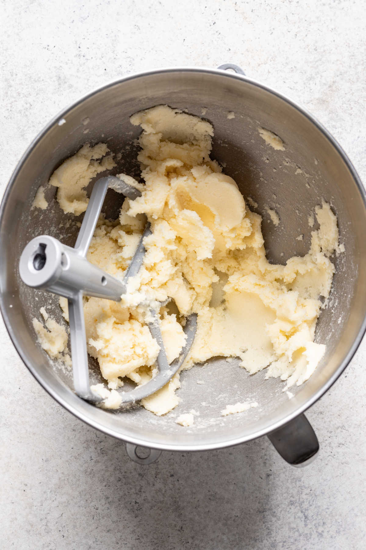 Creamed butter and sugar in a silver mixing bowl. 