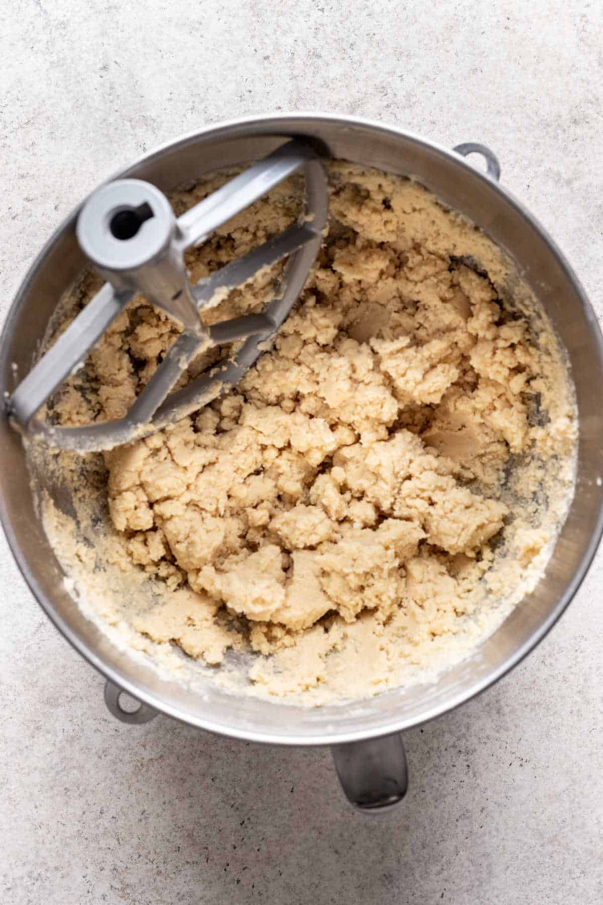 Linzer cookie dough in a silver mixing bowl. 