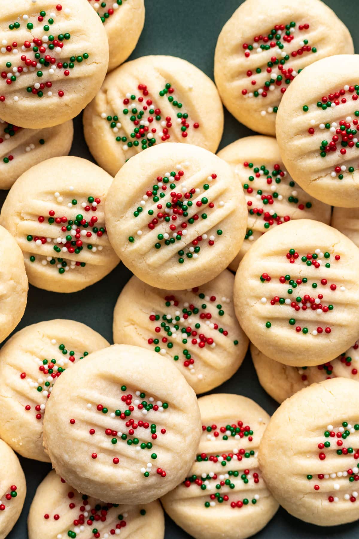 Whipped shortbread cookies topped with nonpareils. 