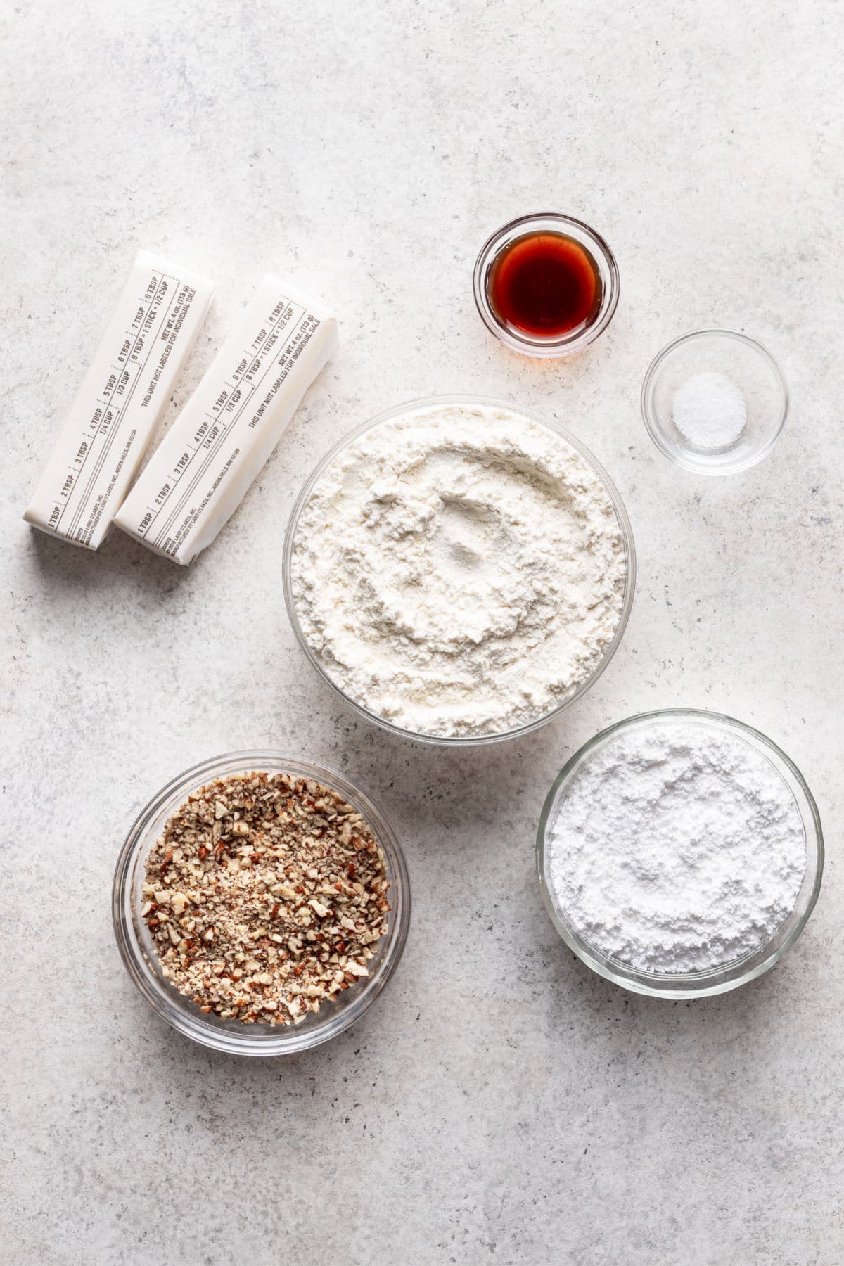 Ingredients for Mexican wedding cookies in dishes. 