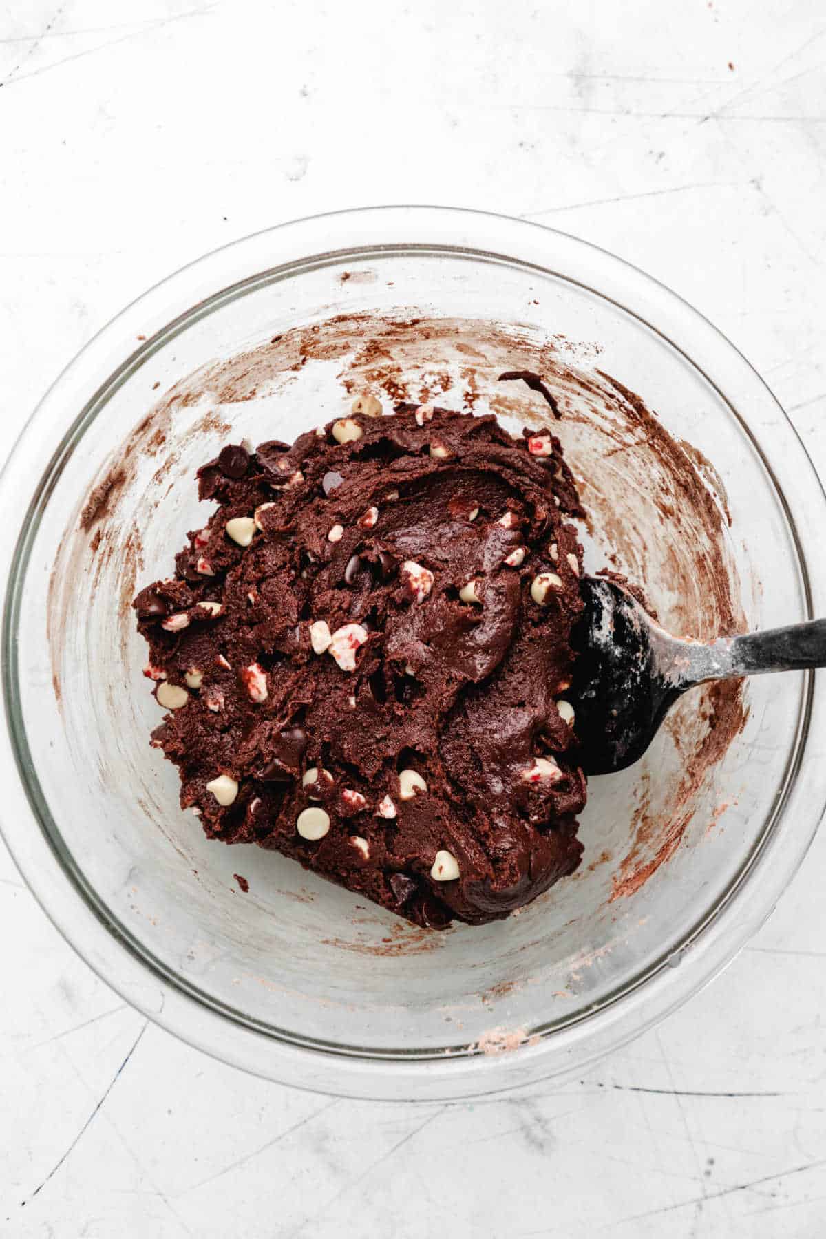 Peppermint bark pieces mixed into chocolate cookie dough. 