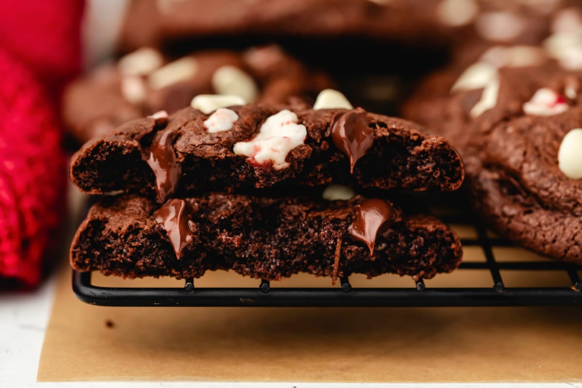 A peppermint bark cookie broken in half on top of each other. 