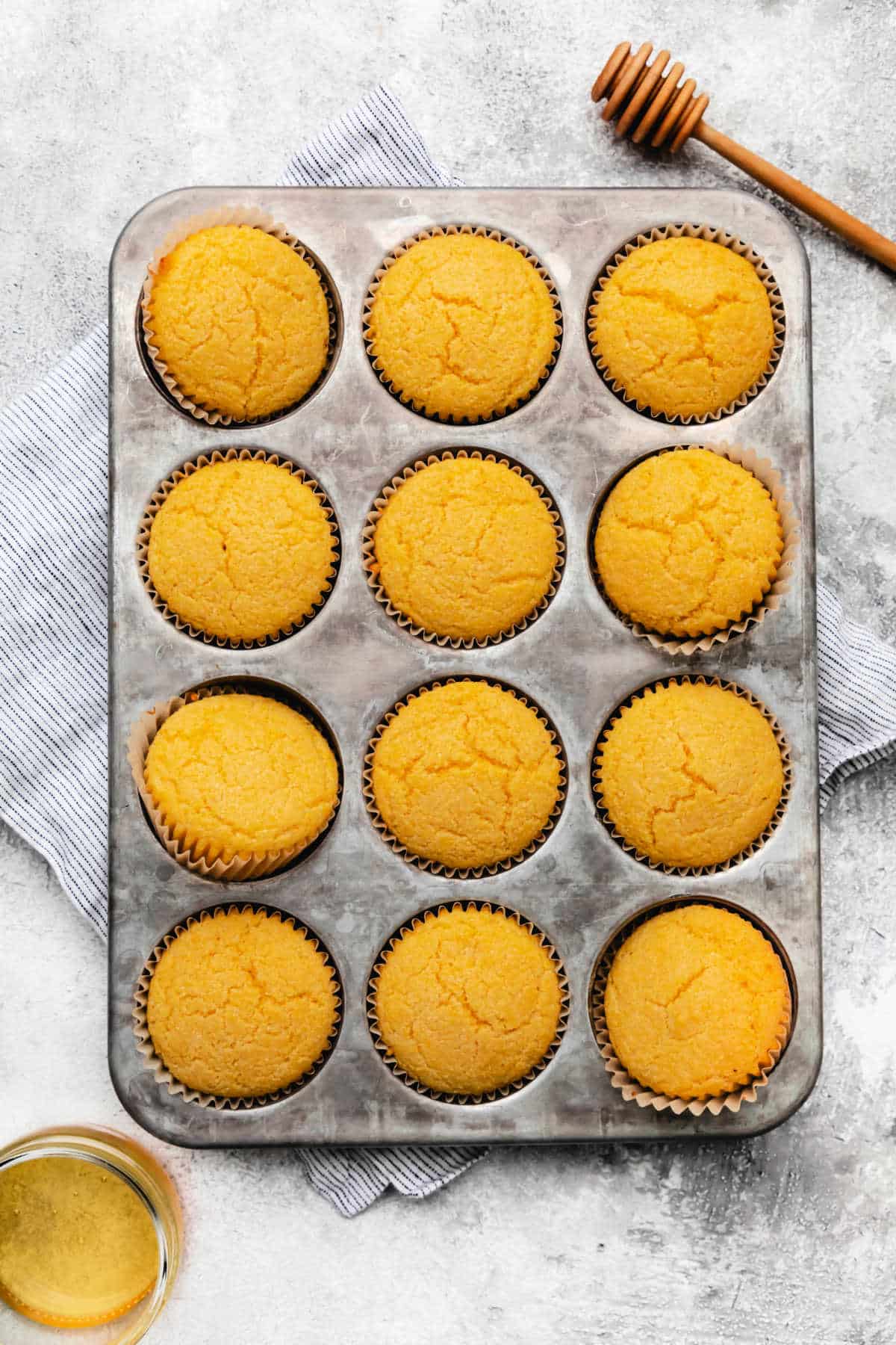 Baked honey cornbread muffins in a muffin tin. 